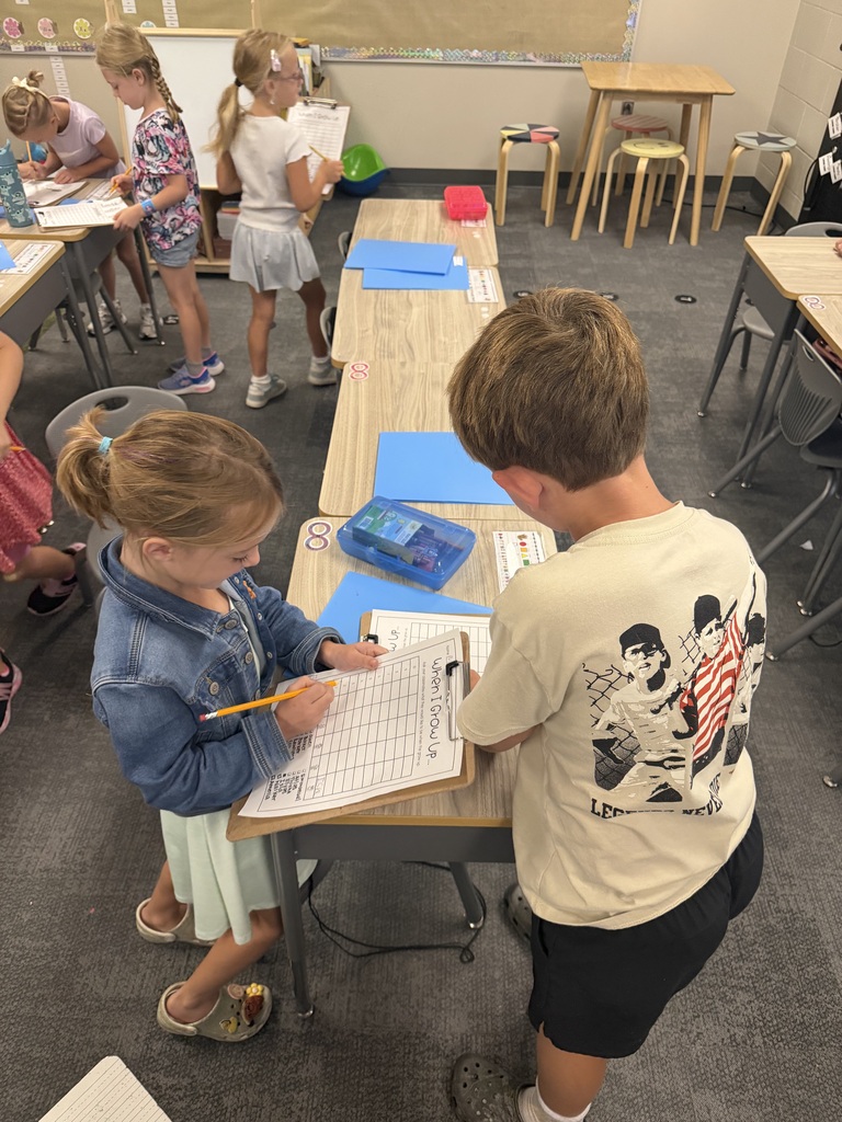 students taking a survey in a classroom with clipboards