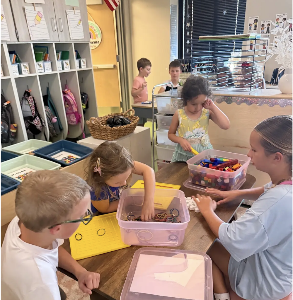 students playing together with rubber band shape makers in a kindergarten classroom