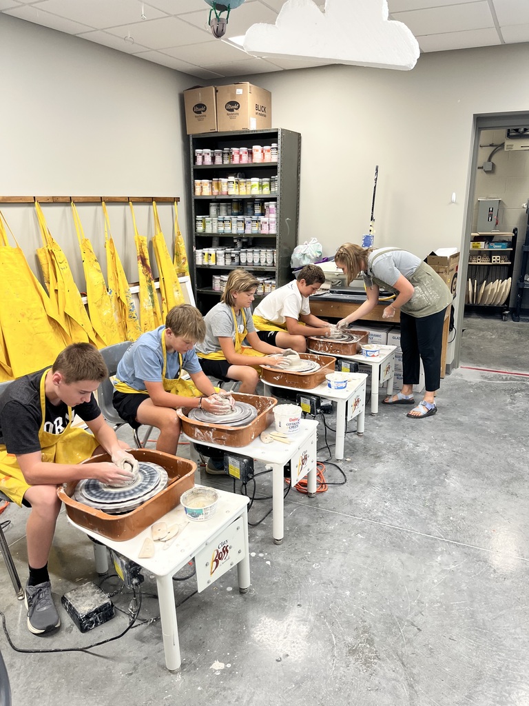 8th grade students on the pottery wheel during art class