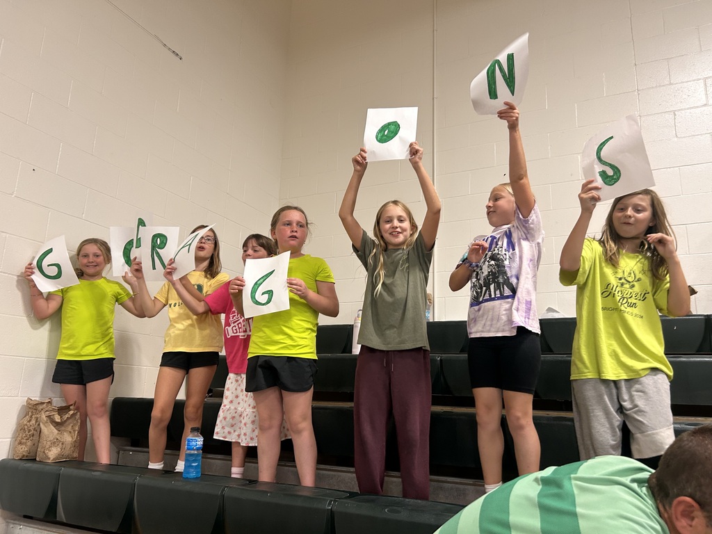 kids holding 'go dragons' signs