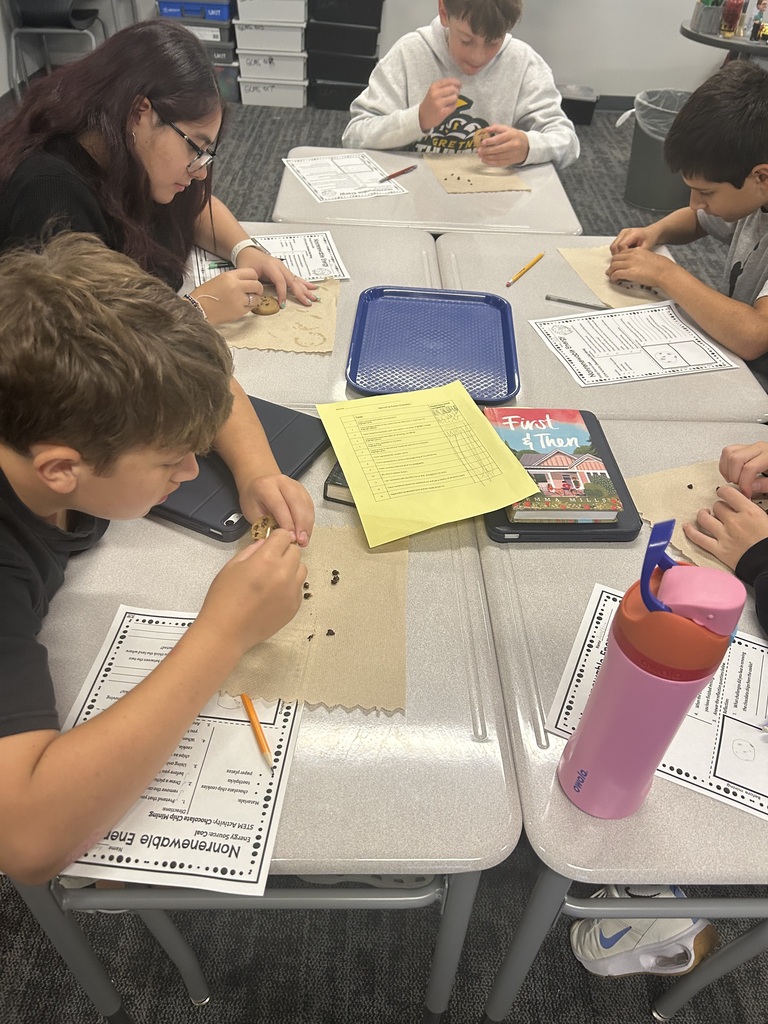 Students are mining chocolate chips out of cookies.