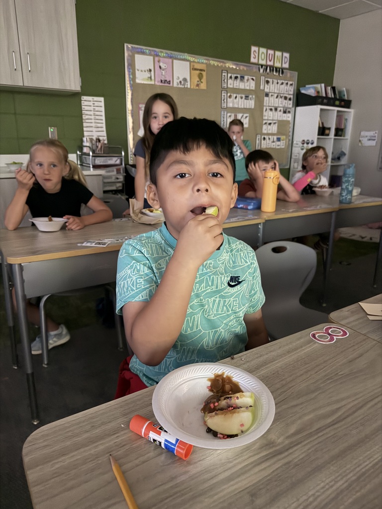 student with an apple tasting