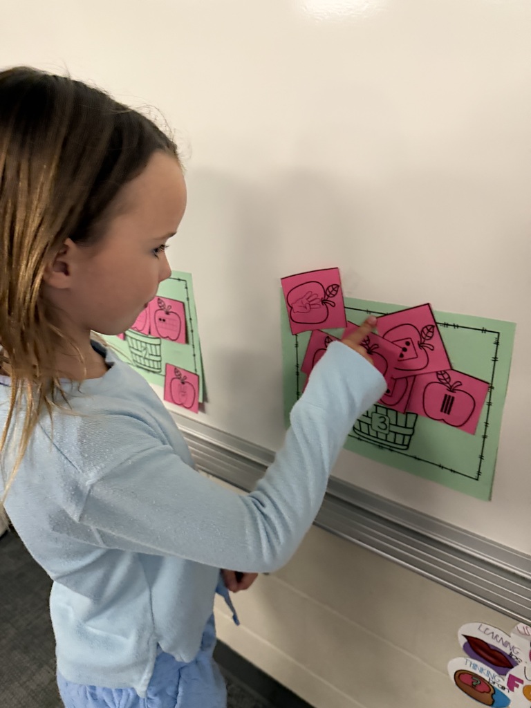 student subatizing with apples
