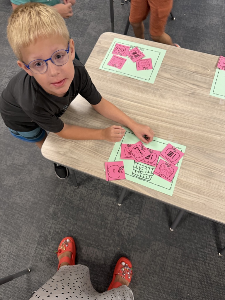 student subatizing with apples