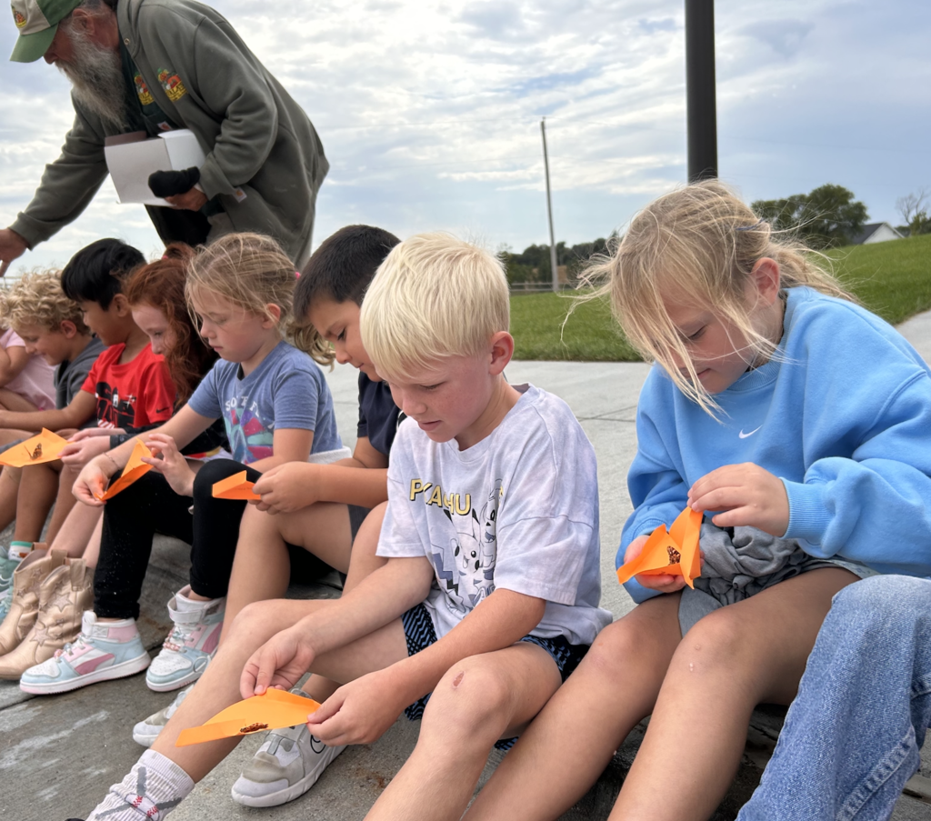 students getting ready to open their butterflies for a release
