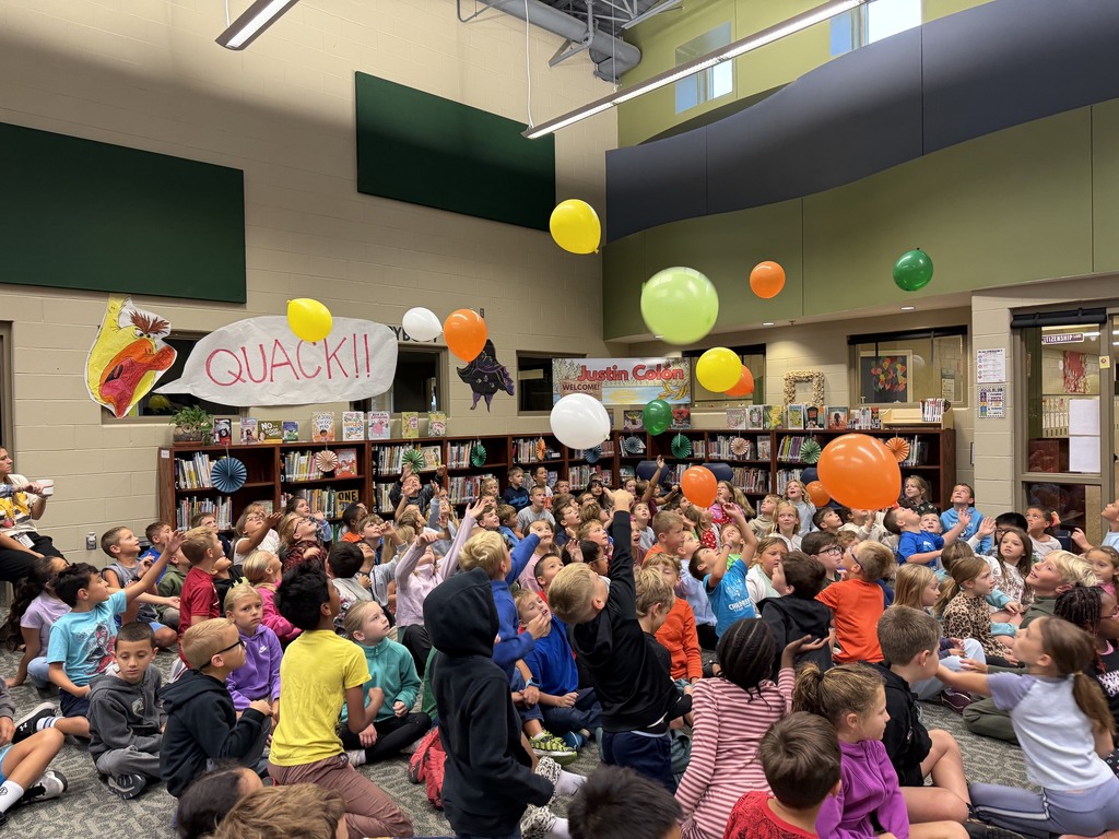 Photo of students hitting balloons into the air