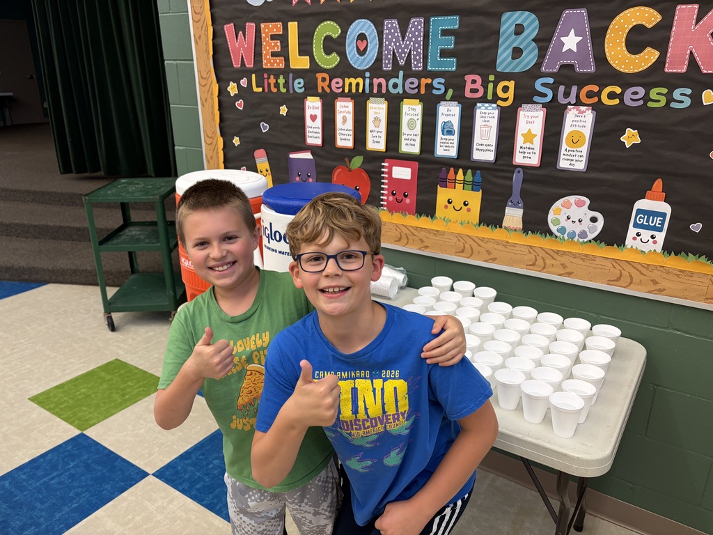 TES students helping with drinks at the pancake man in the cafeteria.