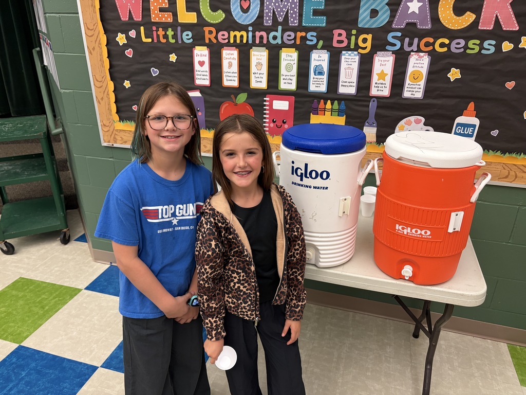 TES students helping with drinks at the pancake man in the cafeteria.