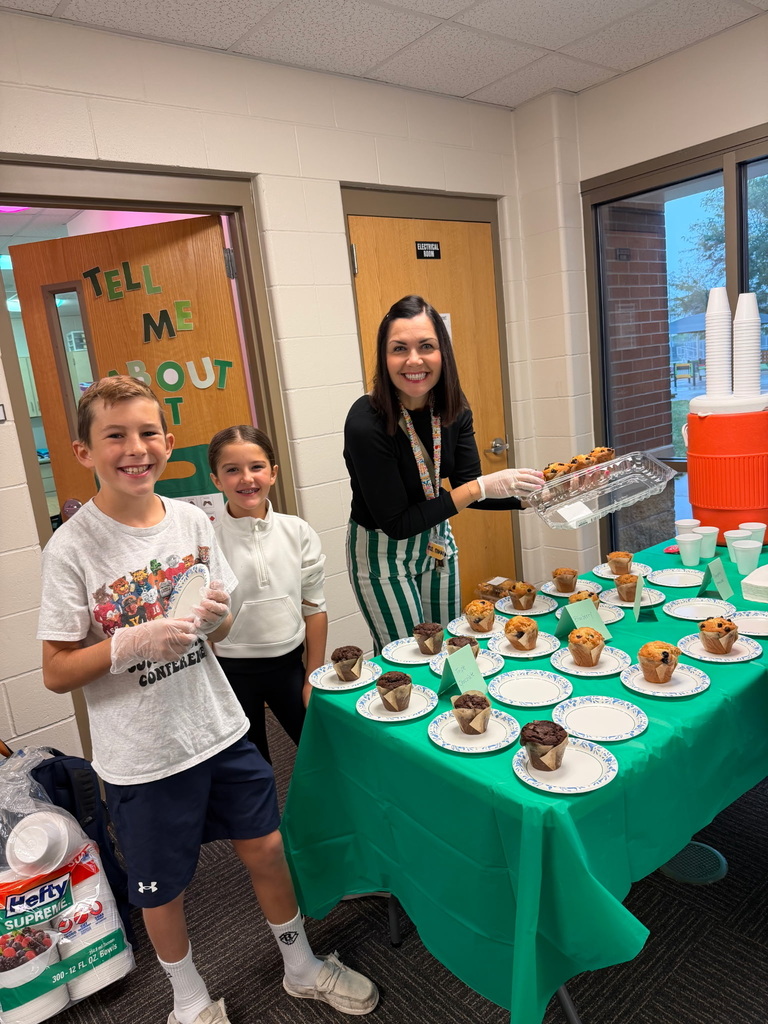PTO Volunteers serving muffins this morning.  