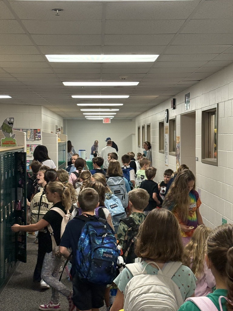 Students and families in the hallways at muffins in the morning.  