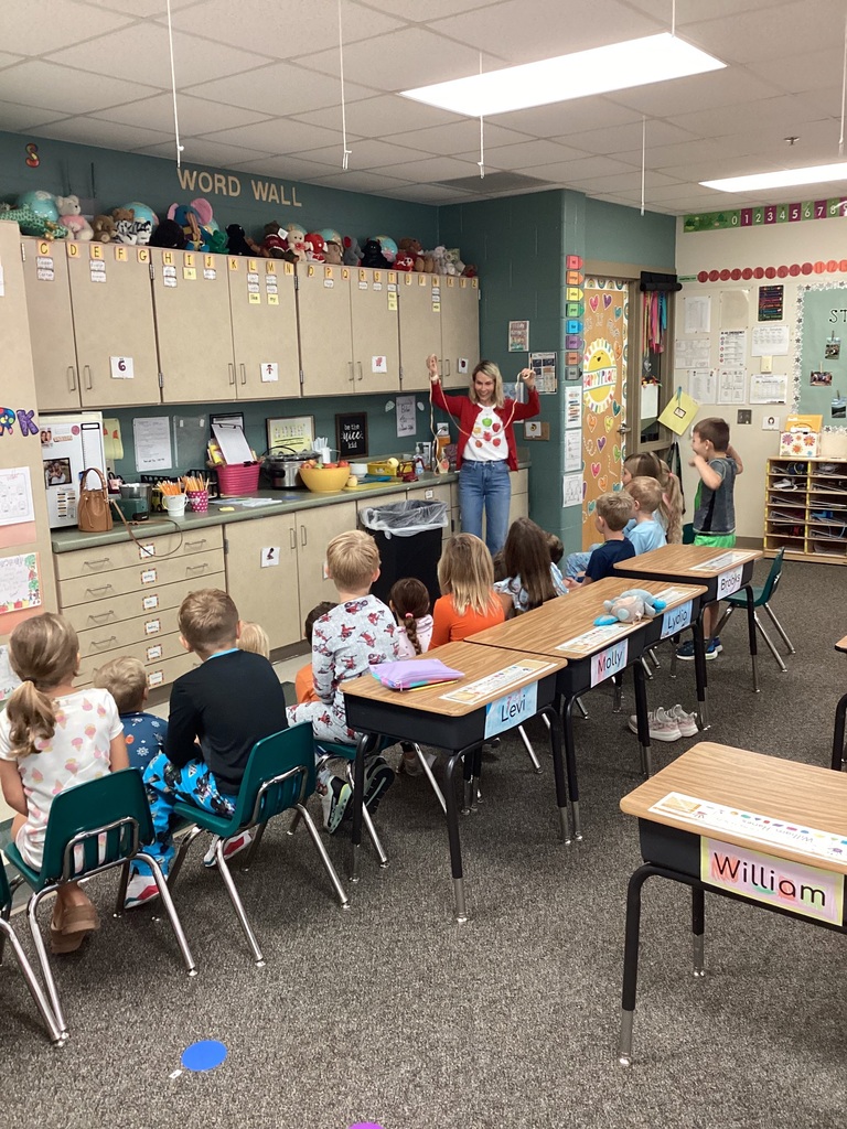 First grade students looking at how long an apple peel is.