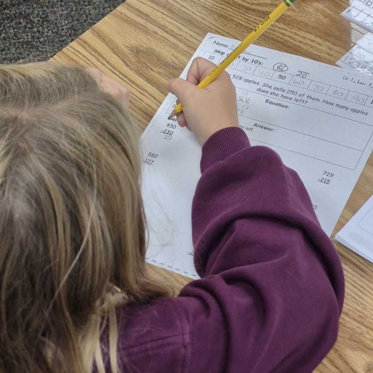 a student working in a math worksheet