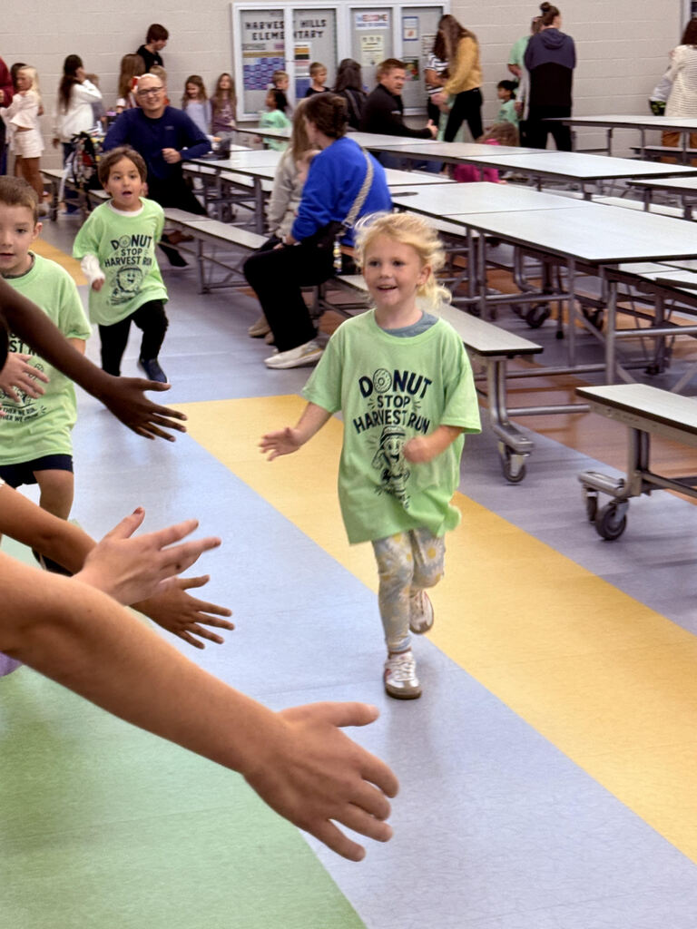 student running in the cafeteria for the harvest run