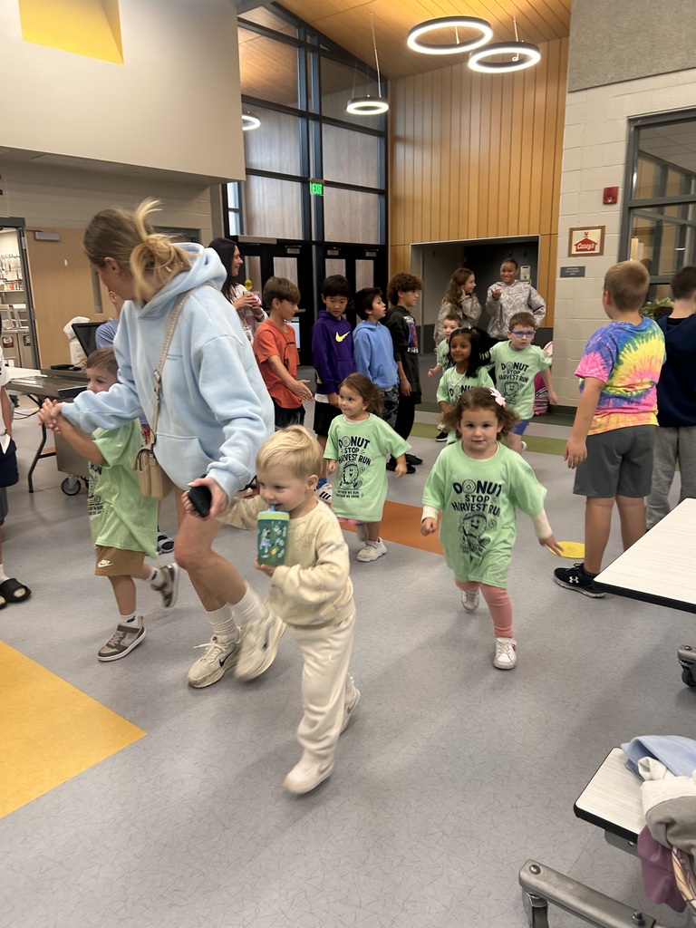 students running in a group in the cafeteria for the harvest run