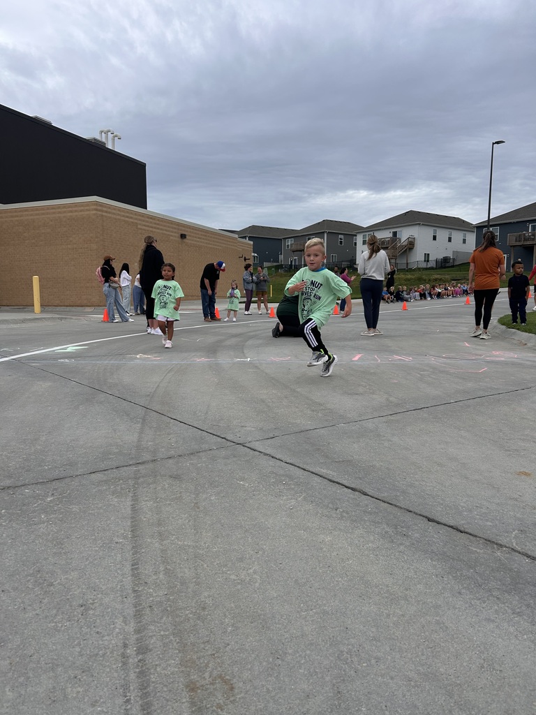 student crosses the finsh line at the harvest run