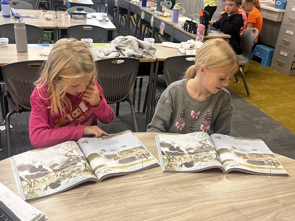 students reading at a table in a second grade classroom