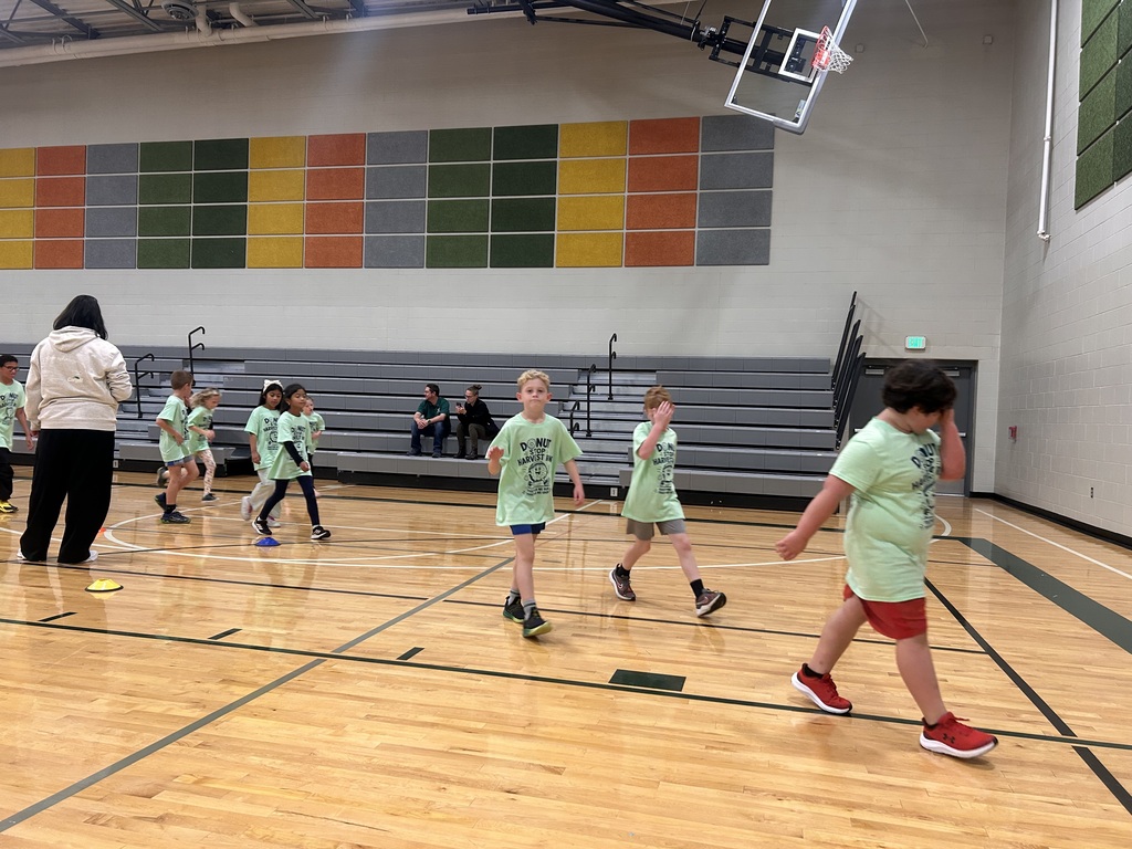 students are running in the gym for a fun run