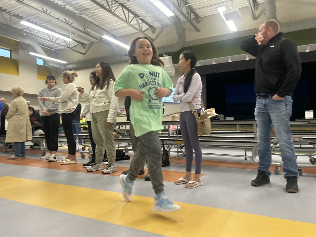 student runs inside at the fun run