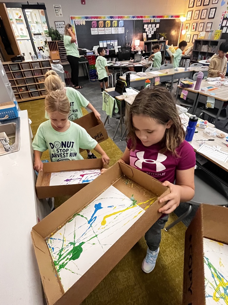 students work on a marble painting project in class
