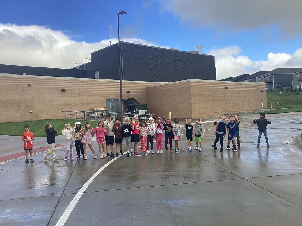 students smiling outside for the camera