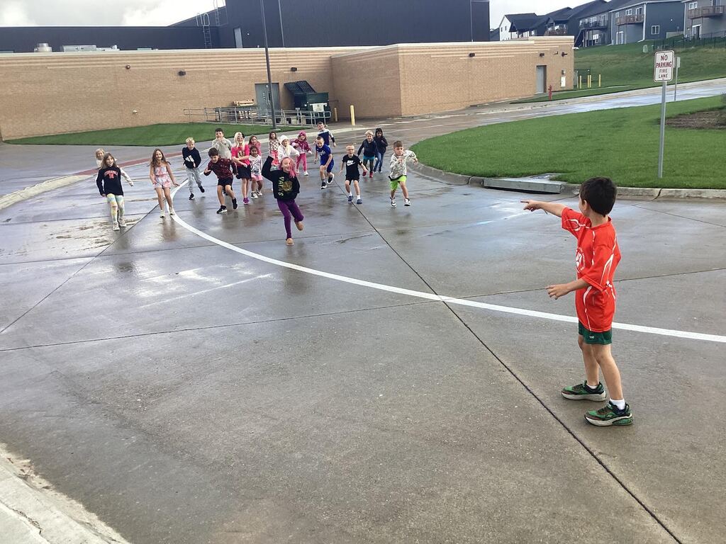 students playing red light green light outside after a rain storm