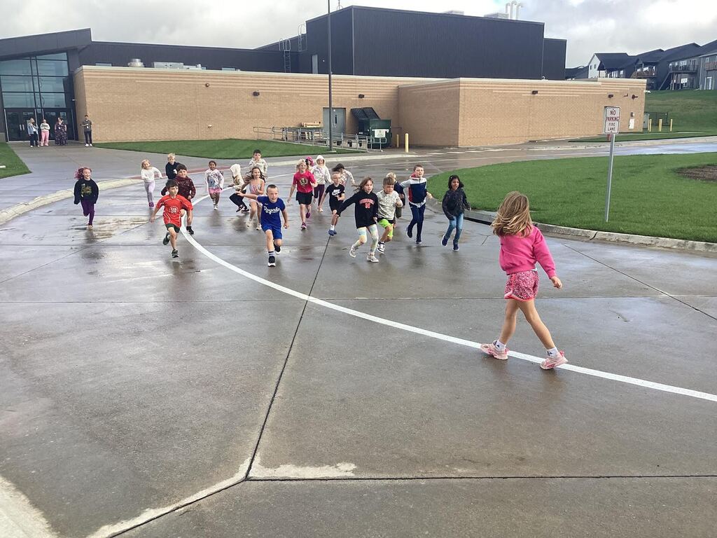 students playing red light green light outside after a rain storm