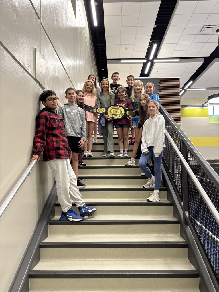 Photo of 6th grade students on the stairwell after celebrating winning the moment at ACMS.