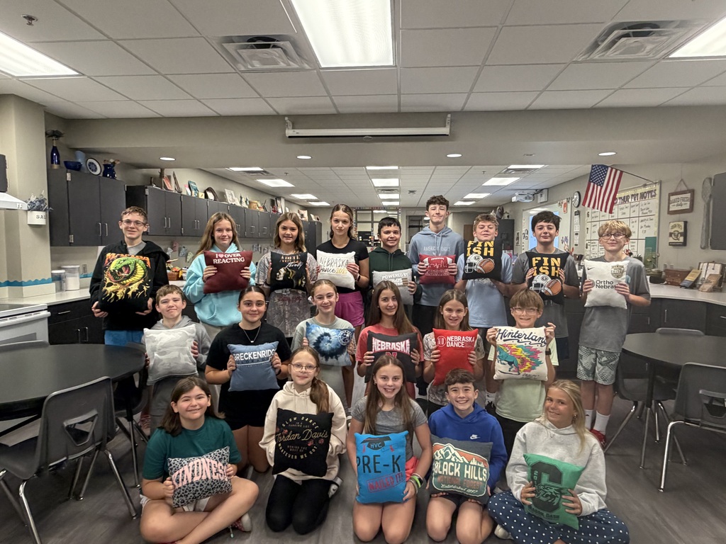 Students holding the pillows they created