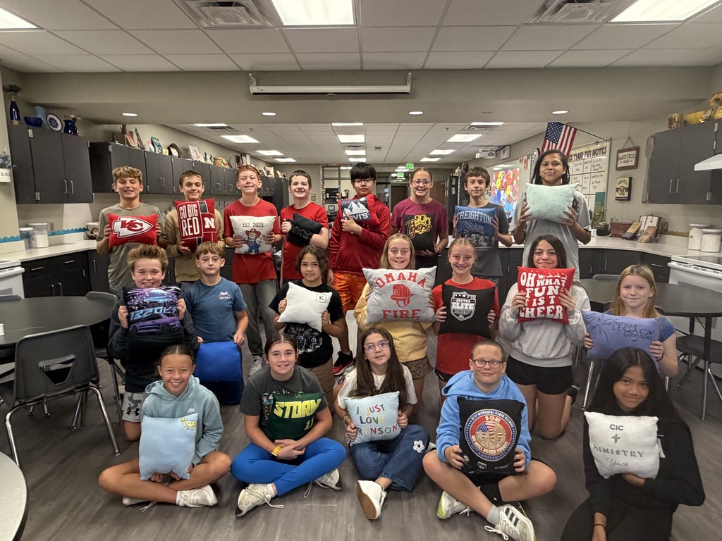 Students holding the pillows they created