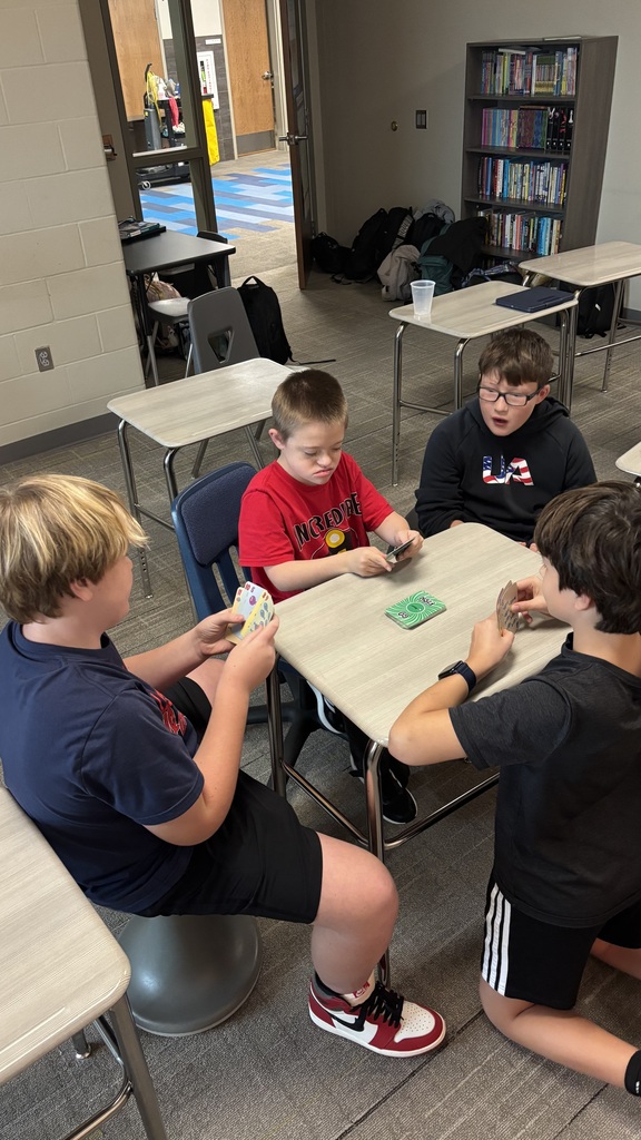 Students playing a card game at Unified Club