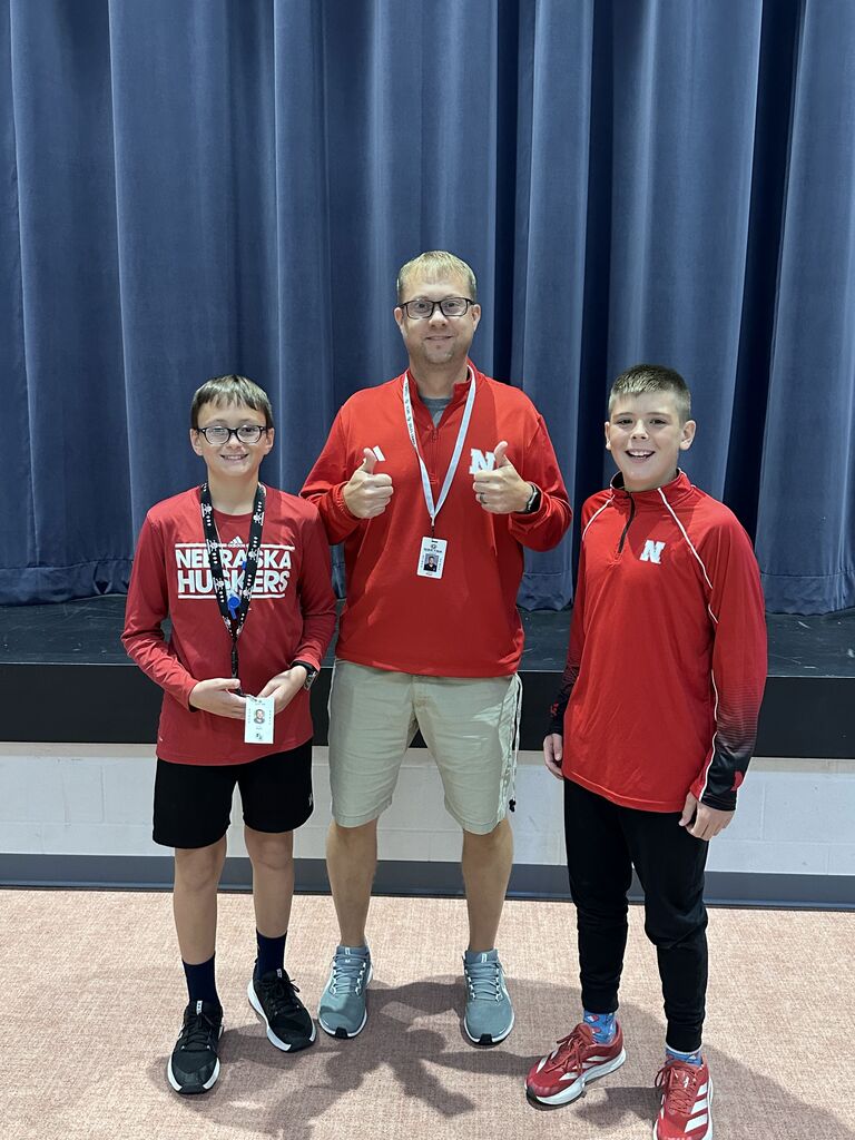Mr. Pryor is with two students giving thumbs up. 