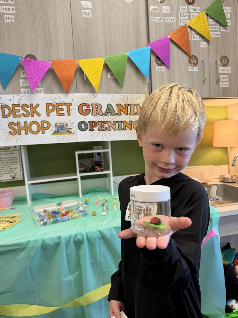 student holding their desk pet