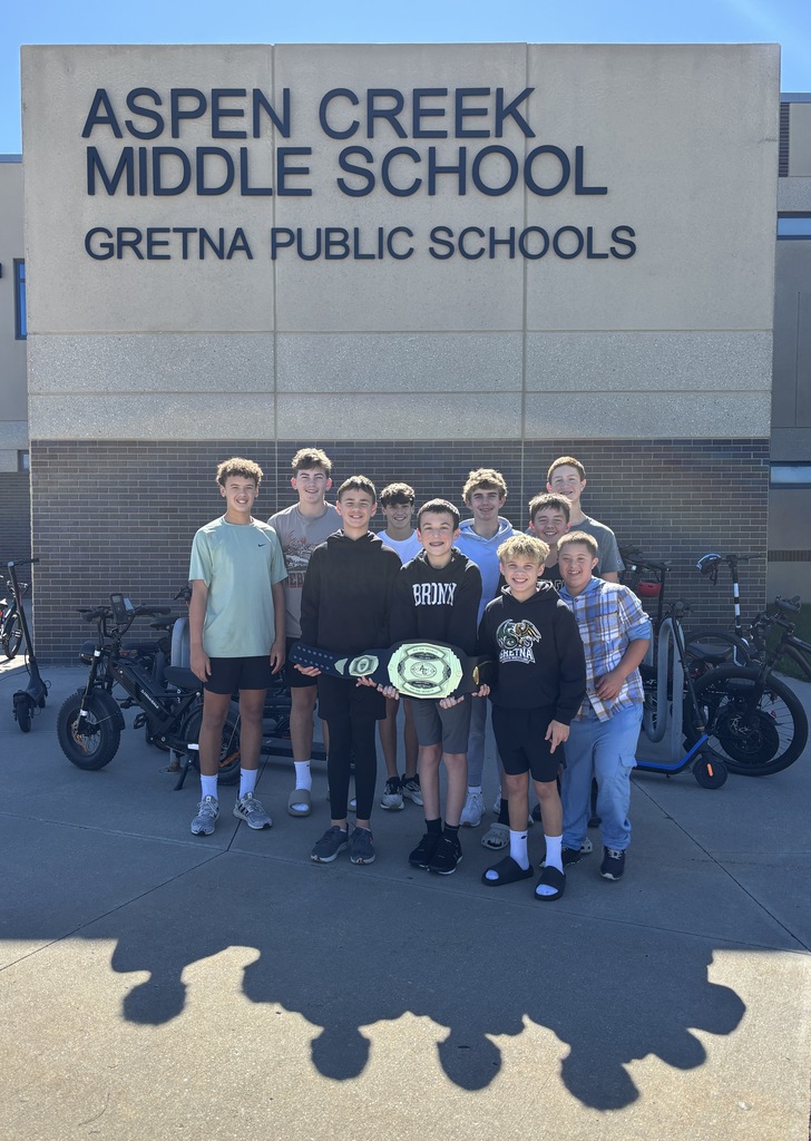 8th graders at ACMS hold the belt while celebrating winning the moment.