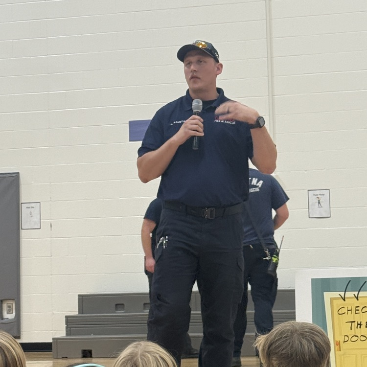 firefighter Bob stands at the front and talks to students 