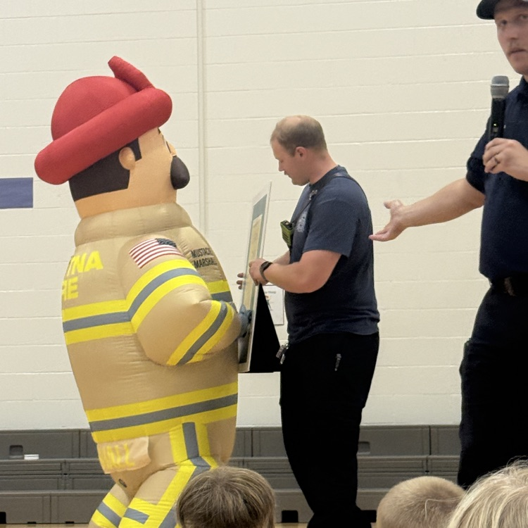 inflatable firefighter Marshall shows how to use the back of our hand to test a door  