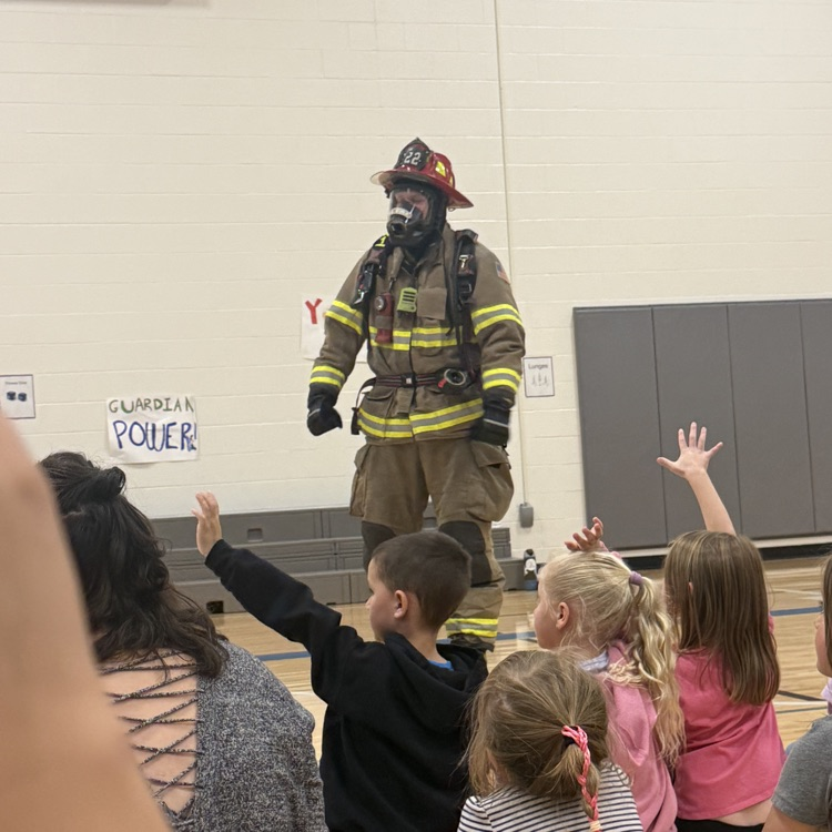 firefighter Greg is in full gear for students to see  
