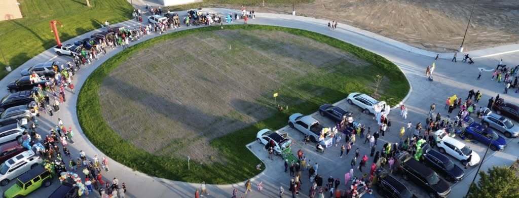 Bus loop aerial view showing students trick or treating.