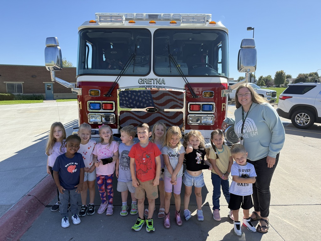Students and teacher in front of a fire truck 