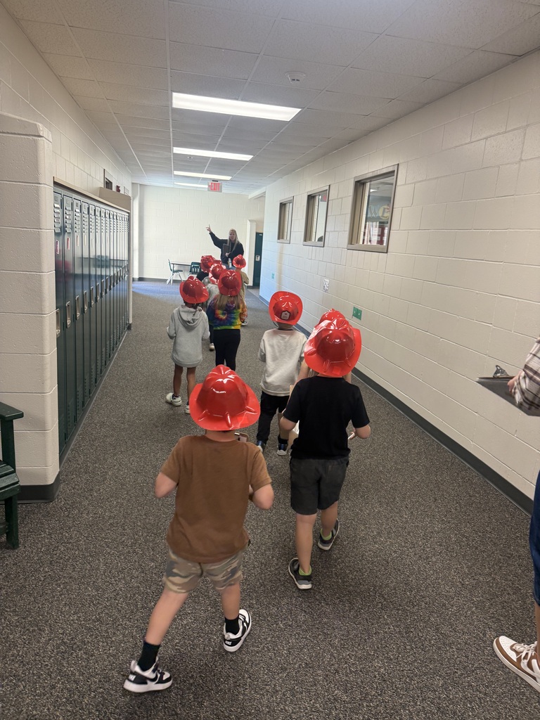 Teacher pointing out an exit sign to students