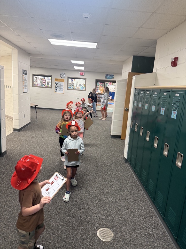 Students walking through the hallways looking for fire alarms