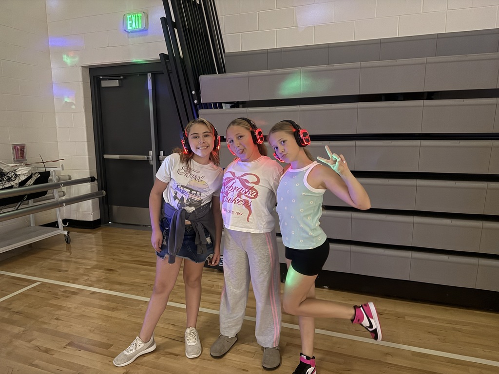 3 fifth grade girls pose with their silent disco headphones