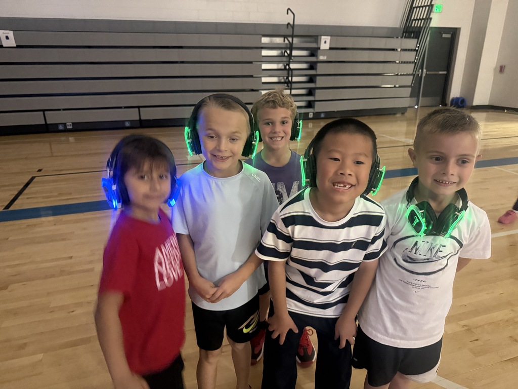 A group of 1st grade boys pose with their silent disco headphones.