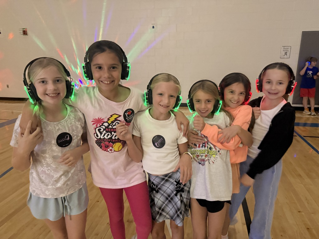 6 third grade girls pose with their silent disco headphones