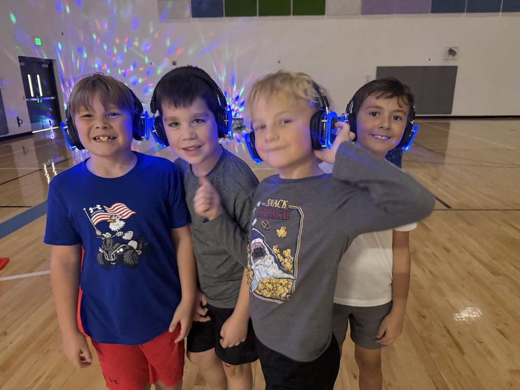A group of 3rd grade boys pose with their headphones