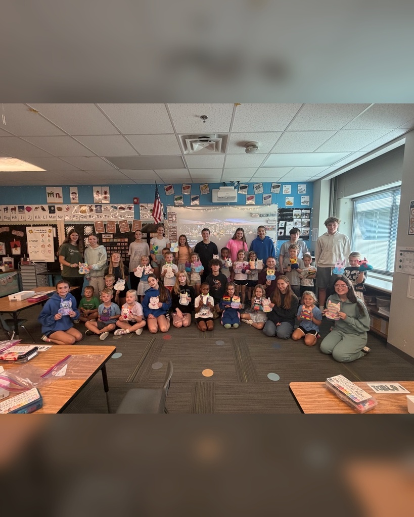 8th grade sewing students and kindergartners with their monster projects from Mrs. Boldt's sewing class