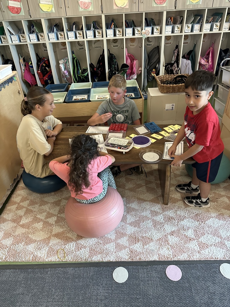 4 students work on an activity together at a table