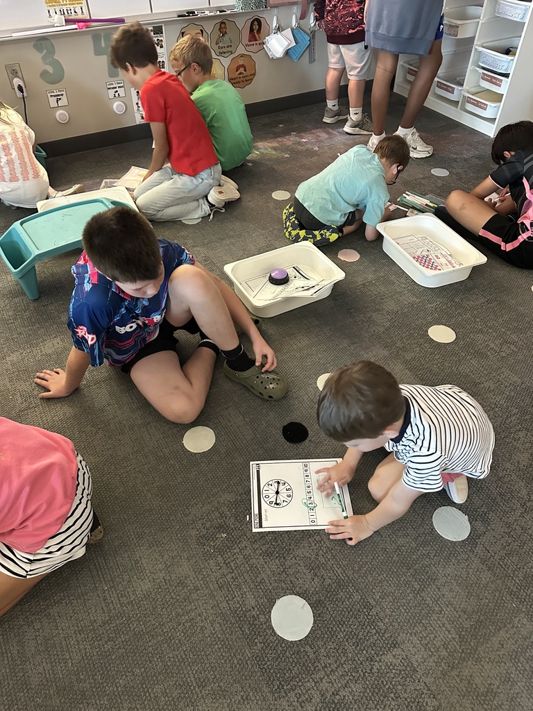 students sit on the floor playing a game