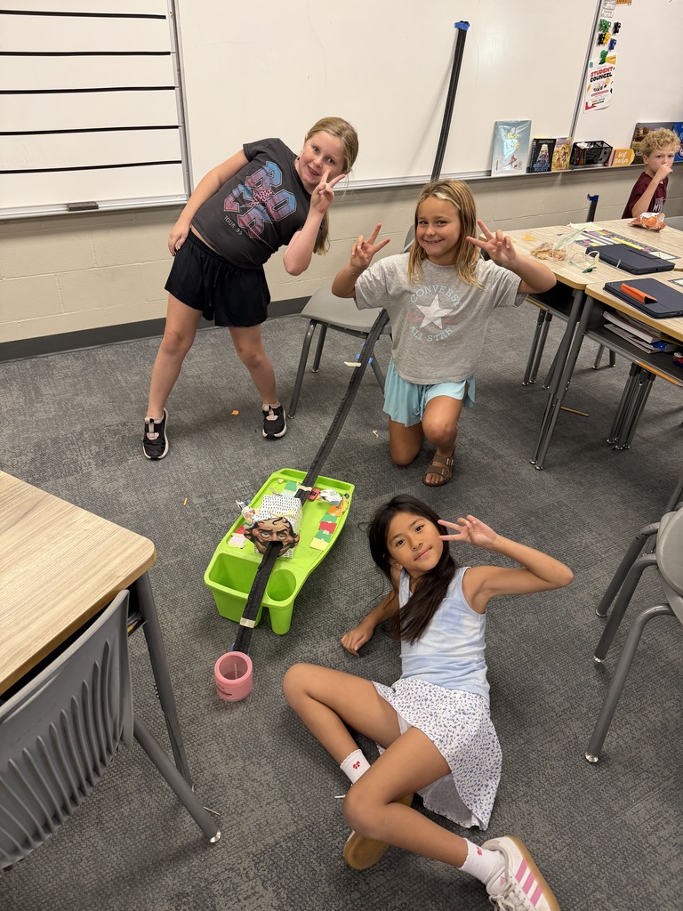 three students create a track in science class