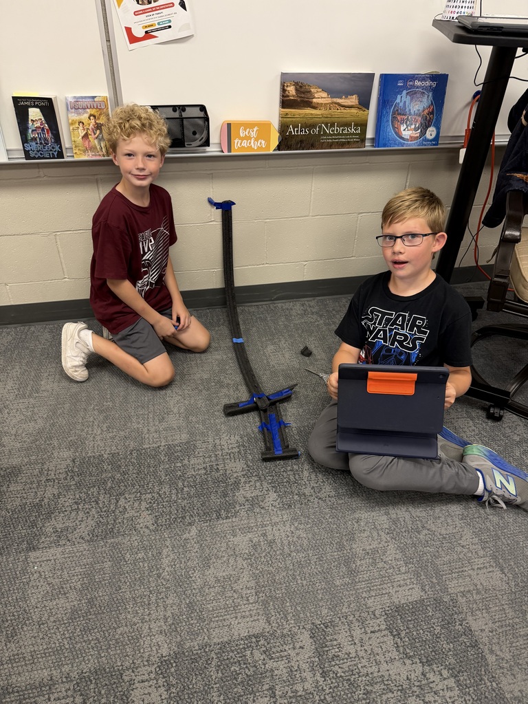 students working on a track in science class