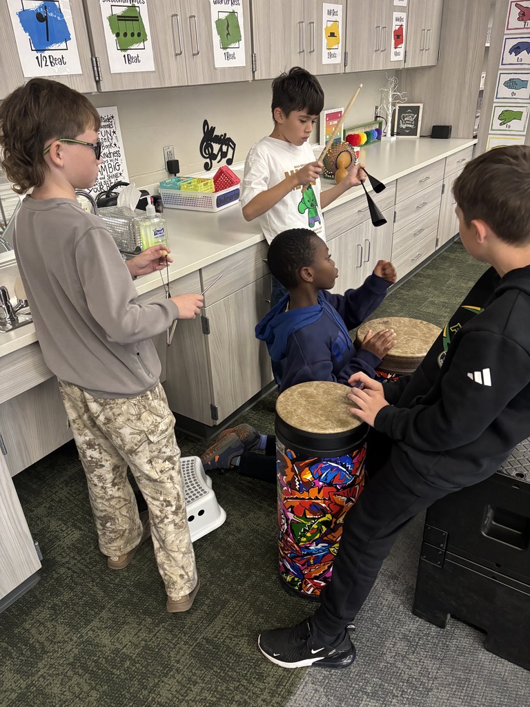 Students in Miss Beach's music class working hard on their drum ensembles
